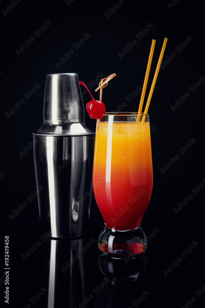 Glass of Sex on the Beach cocktail and shaker against black background  Stock Photo | Adobe Stock