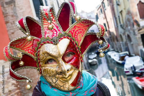 Woman in colorful joker mask at The Carnival of Venice 2018