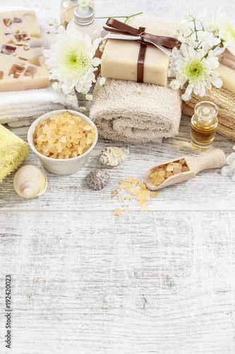 Spa cosmetics on white wooden table.