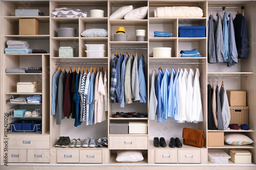 Fotografiet Big wardrobe with male clothes for dressing room