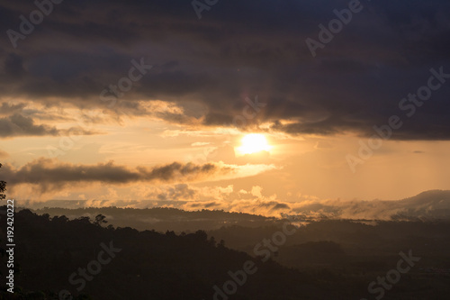scene raining among a mountains during sunset