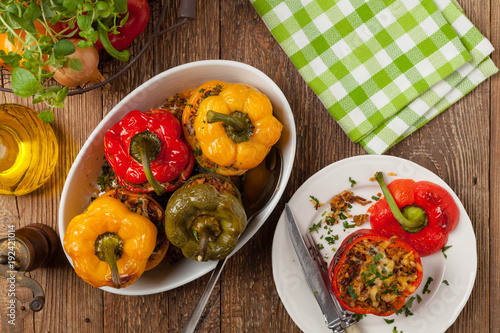 Colorful baked with cheese, stuffed peppers with rice and minced meat.