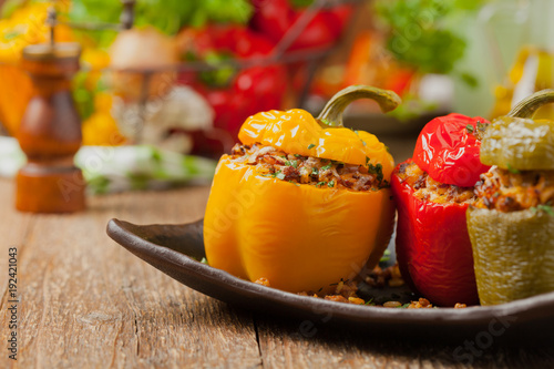 Colorful baked with cheese, stuffed peppers with rice and minced meat.