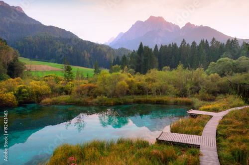 Sunset view of beautiful Zelenci lake with clear turquoise water near Kranjska Gora, Slovenia photo