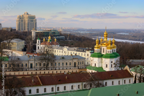Kyiv landscape with Kiev Pechersk Lavra structures, modern buildings and Dnieper river on background.