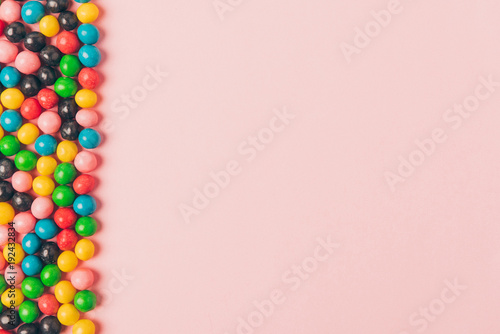 top view of arranged candies isolated on pink