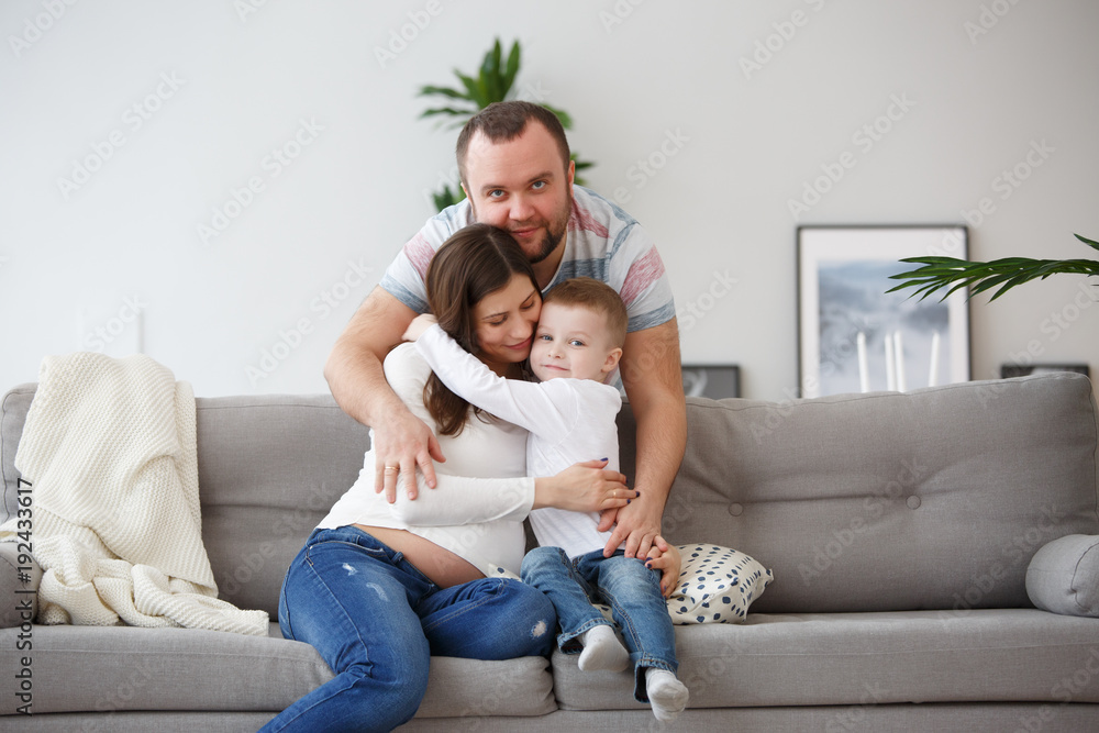 Photo of happy family with son on gray sofa