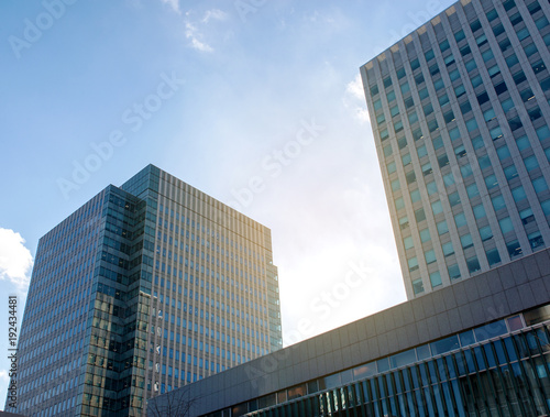 Common modern business   high-rise buildings  architecture raising to the blue sky with sunlight . Concepts of financial  business