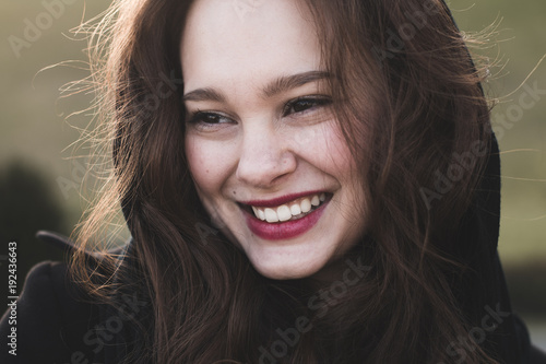 Beautiful smiling woman portrait outdoor. Young cheerful woman smiling. Carefree, happy woman.