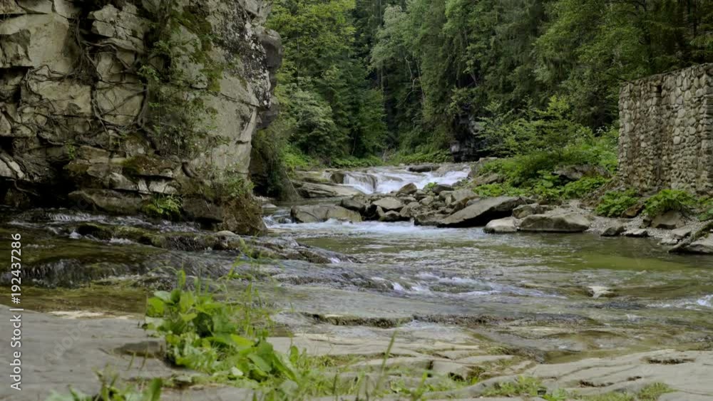 Sliding video of mountain river in canyon with man made stone fence in side Sliding video of mountain river in canyon with man made stone fence in side