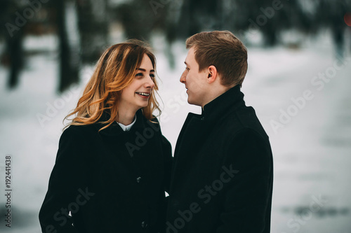 Winter LoveStory in Valentine's day. Girl and guy happy and smiling photo