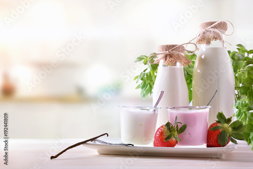 Strawberry and natural yogurt on wooden table front