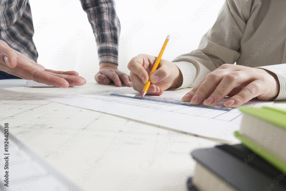 Architects working on blueprint, real estate project. Architect workplace - architectural project, blueprints, ruler, calculator, laptop and divider compass. Construction concept. Engineering tools. Architects working on blueprint, real estate project. Architect workplace - architectural project, blueprints, ruler, calculator, laptop and divider compass. Construction concept. Engineering tools.