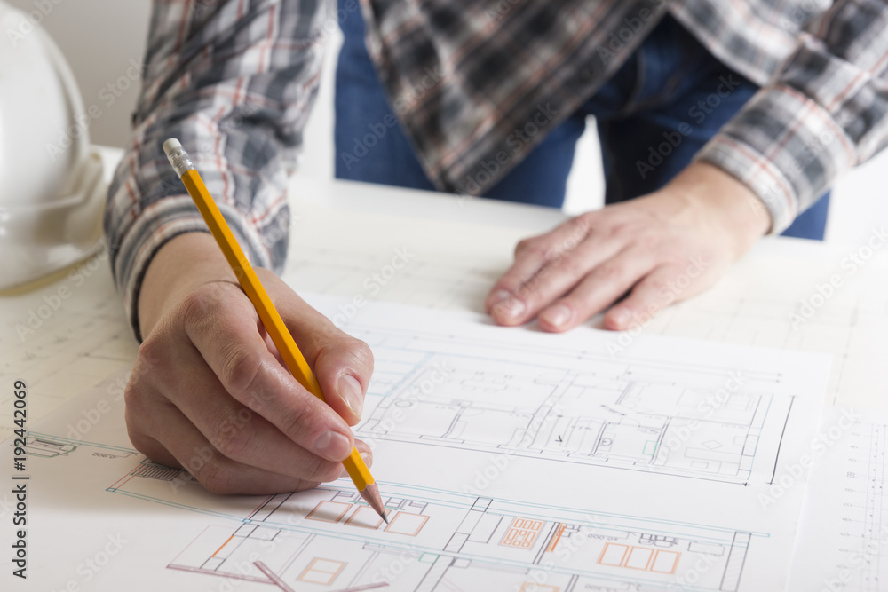 Architects working on blueprint, real estate project. Architect workplace - architectural project, blueprints, ruler, calculator, laptop and divider compass. Construction concept. Engineering tools. Architects working on blueprint, real estate project. Architect workplace - architectural project, blueprints, ruler, calculator, laptop and divider compass. Construction concept. Engineering tools.