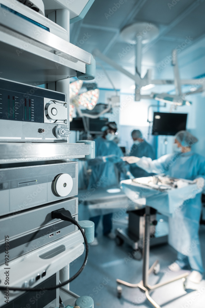 four surgeons in operating room in hospital four surgeons in operating room in hospital