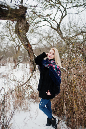Blonde girl with hand embroidered scarf posed at winter day. Women's handkerchief.