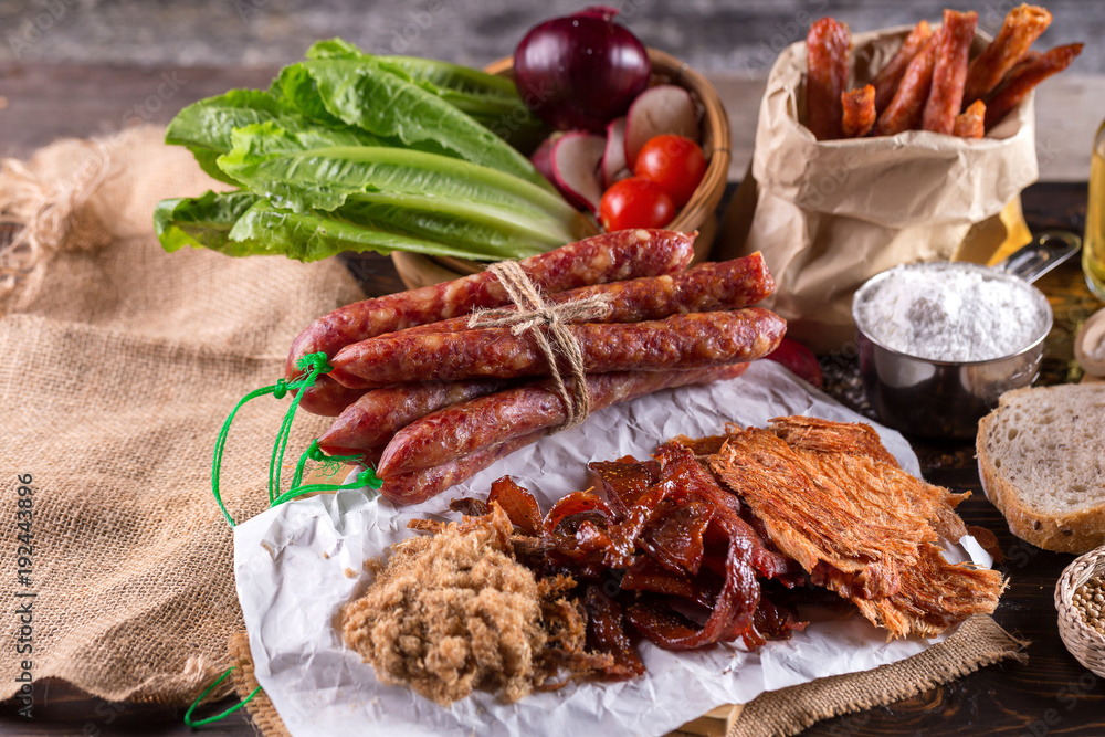 Chinese sausage and Pounded pork jerky for cook on a wooden background