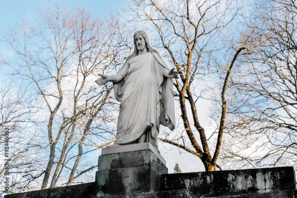 Welcoming Statue of Jesus on a Pedestal found on a Cemetery