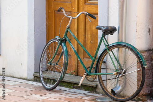 Old bicycle in front of the house door, traditional mode of transportation for healthy life