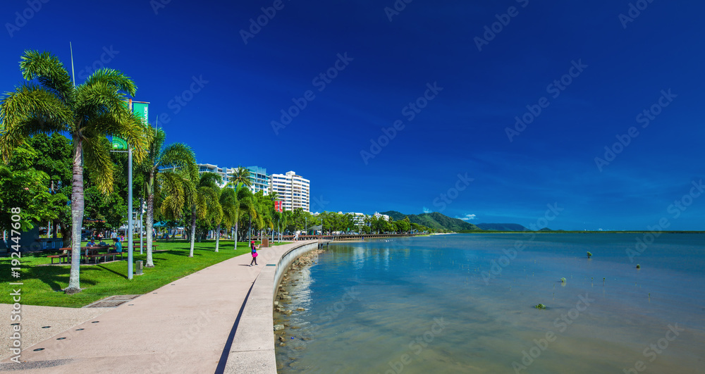 CAIRNS, AUSTRALIA - 27 MARCH 2016. The Esplanade in Cairns with palm trees and the ocean, Queensland, Australia.