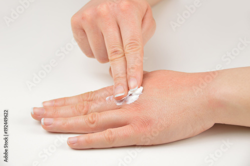 hand and putting moisturizer