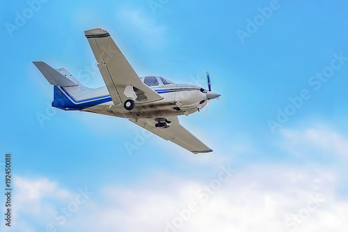 a single-engine plane on blue sky background