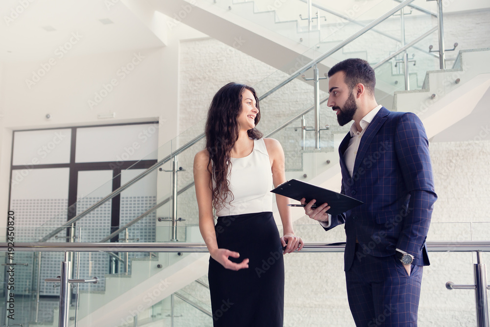 Fototapeta premium Two business colleagues talk about work outside office.