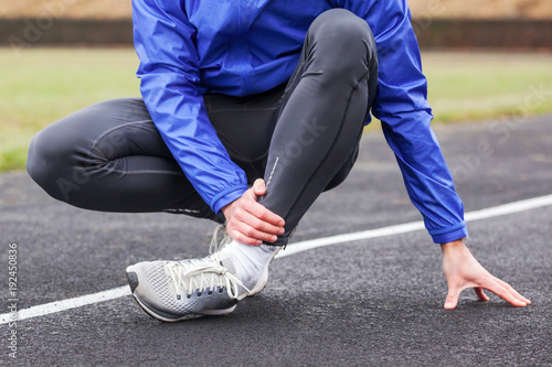 Cropped shot of a young man holding his ankle in pain sprain a foot.