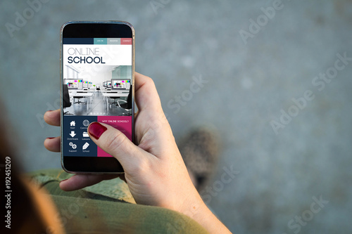 Woman walking smartphone online school interface