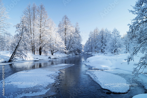 Winter landscape with river in wood
