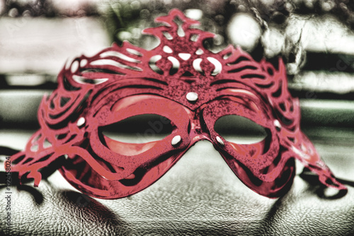 Elegant mask on a leather table