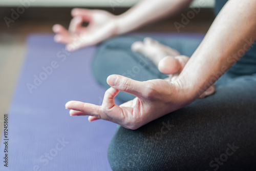 Yoga in lotus pose with woman meditating in peace relaxing in gym class
