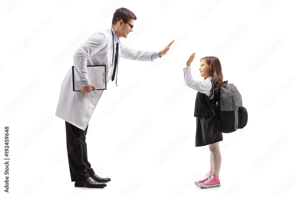 Doctor high-fiving with a little schoolgirl Doctor high-fiving with a little schoolgirl