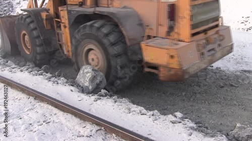 Work autoloader in a career. Heavy equipment with a bucket collects stones. photo