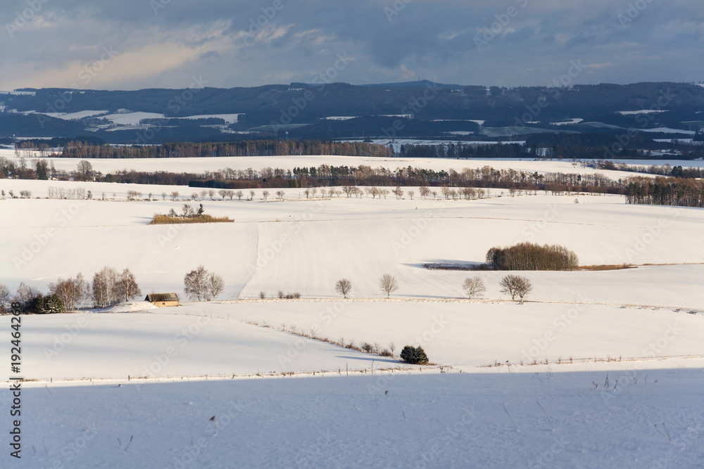 Vintage wooden fence poles in beautiful snowy peaceful winter country mountains landscape on sunny day, weather forecast concept, Czech Republic