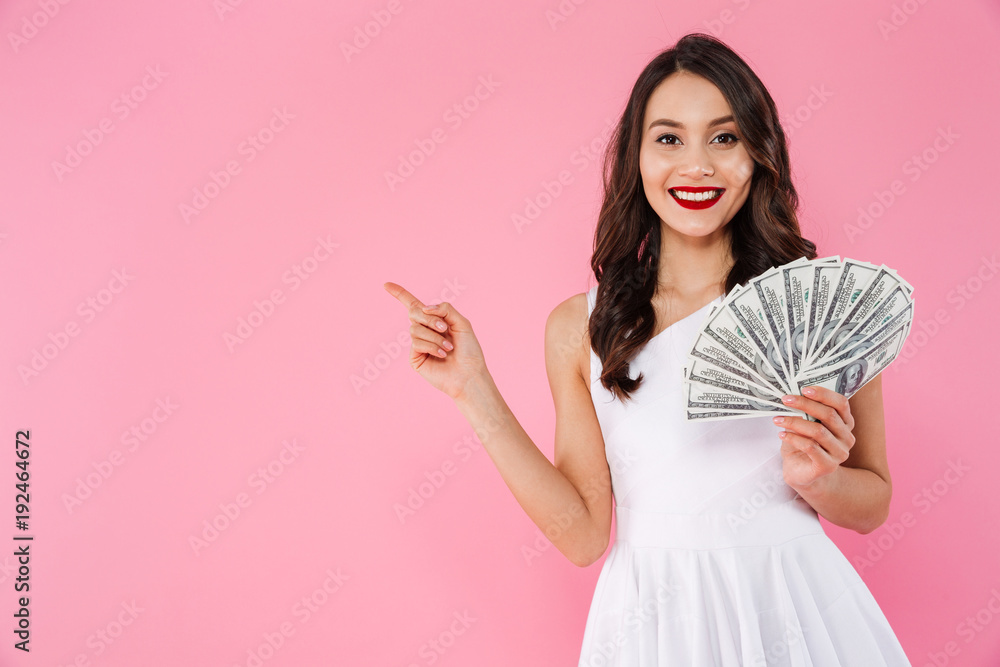 Φωτογραφία Image of successful asian woman 20s holding fan of money in dollar cash and poin