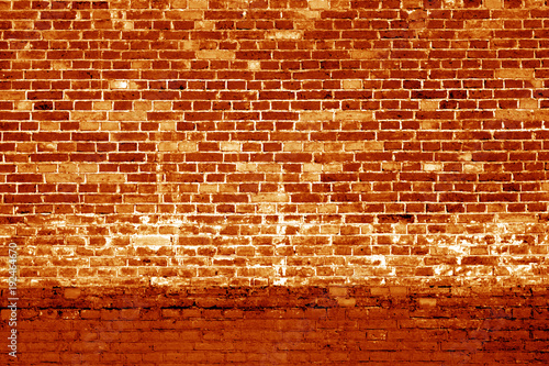 Weathered brick wall background in orange tone.