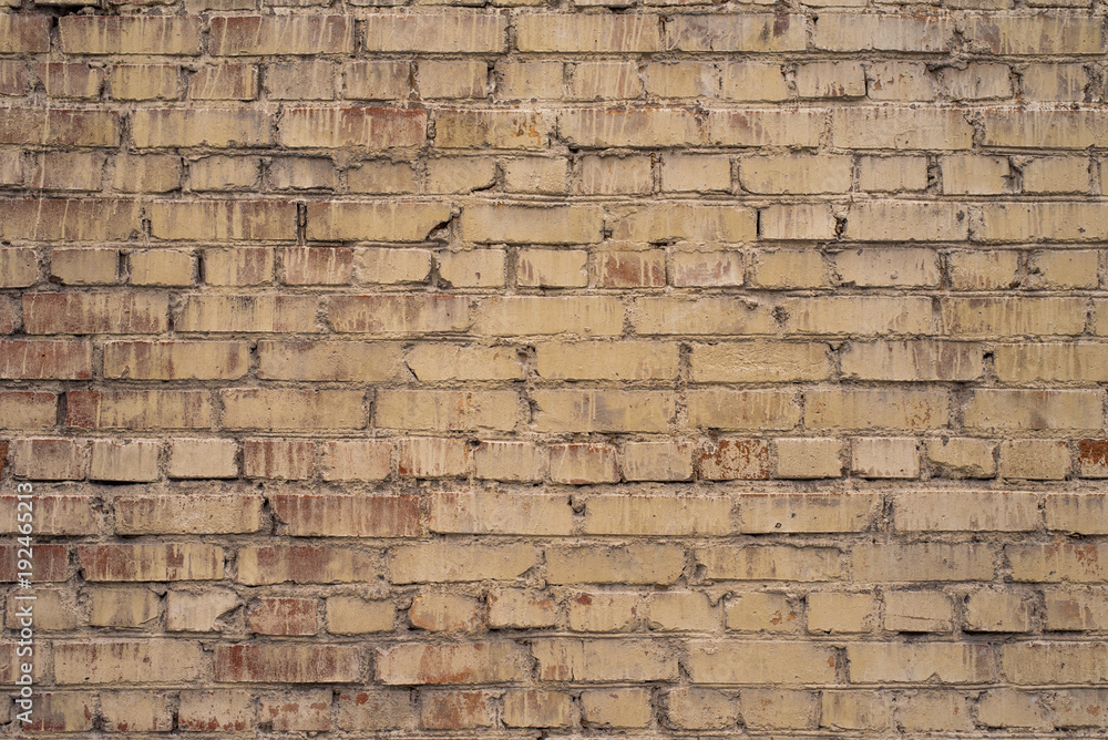 Obraz premium Old brickwork painted in yellowish color - retro background