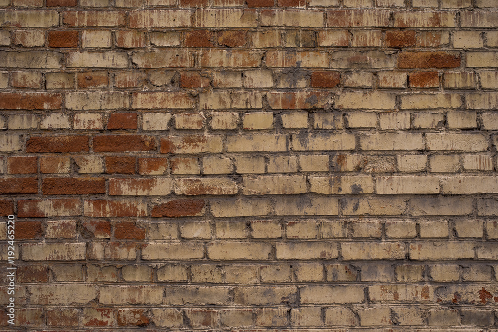 Old brick wall with the remains of paint - a retro background Old brick wall with the remains of paint - a retro background