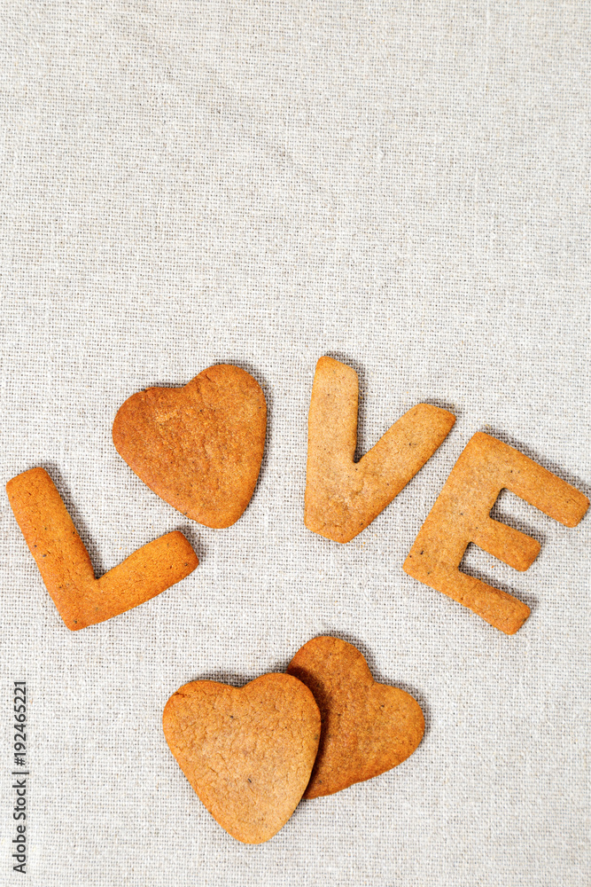 Edible letters of the word love. Shortbread cookies in the form hearts and  letters. Vertical format with copy space. Stock Photo
