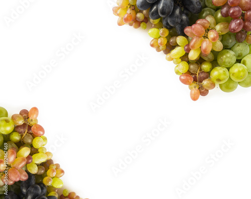 Top view. Grapes on white background. Grapes with copy space for text. Blue, red and green grapes. Vegetarian or healthy eating.