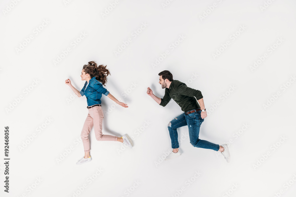 top view of couple pretending to run isolated on white
