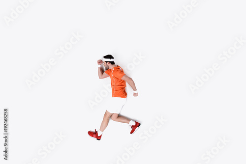 top view of young man in sportswear running isolated on white