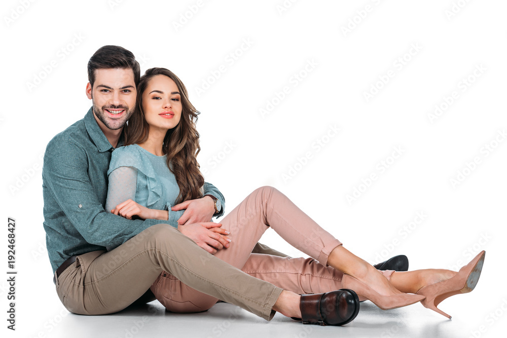 beautiful happy couple sitting on floor on white beautiful happy couple sitting on floor on white