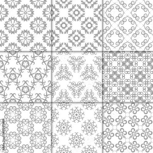 Gray and white floral ornaments. Collection of seamless patterns
