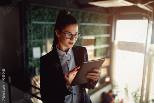 Young businesswoman using tablet computer. Girl surfing the internet. photo