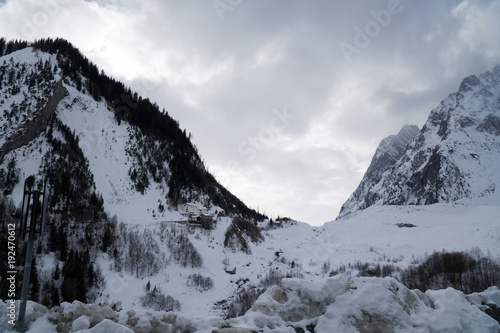 Granite mountains covered with snow and winter forest near Mont Blanc Alpes, Italy © Didi
