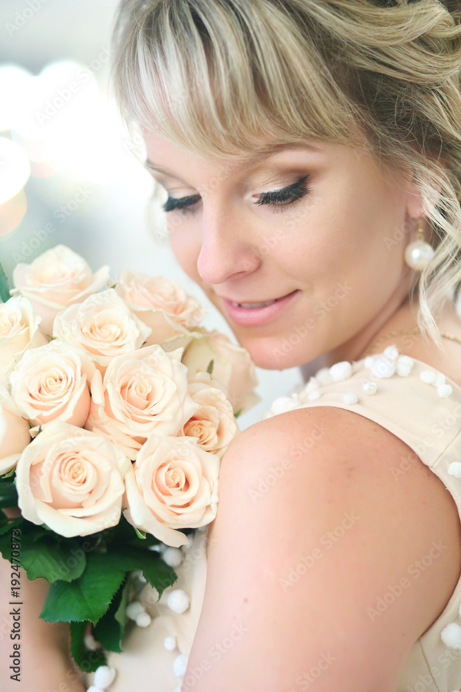 beautiful blonde bride with a bouquet of white roses beautiful blonde bride with a bouquet of white roses