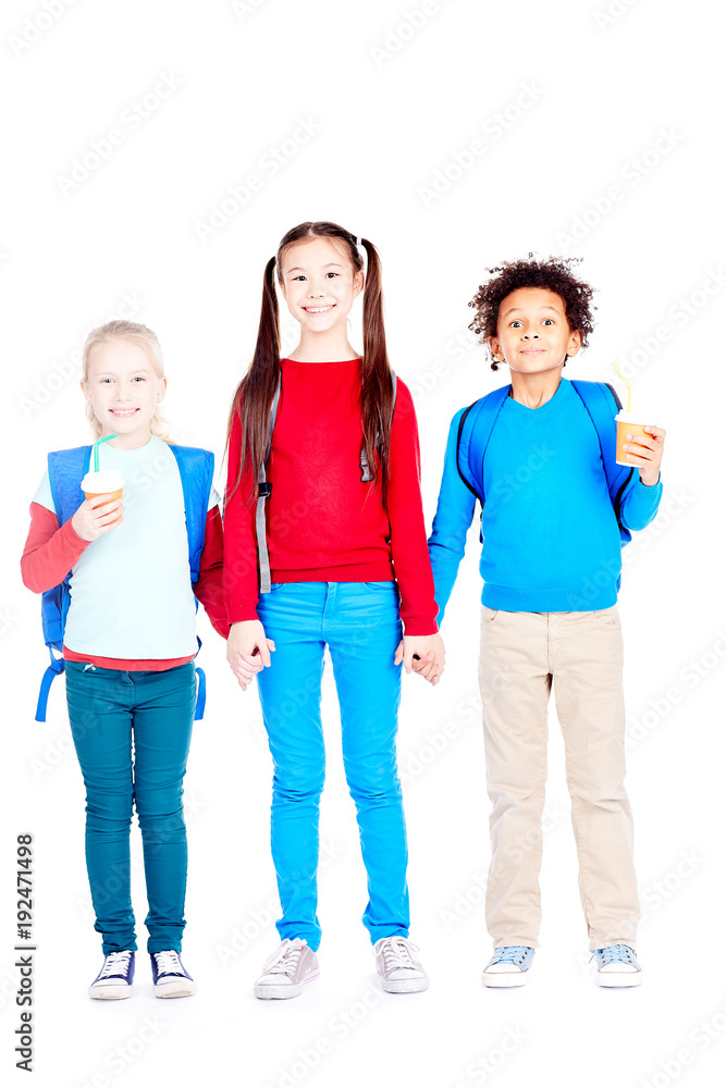 Portrait of three multi-ethnic school friends holding hands on white background Portrait of three multi-ethnic school friends holding hands on white background