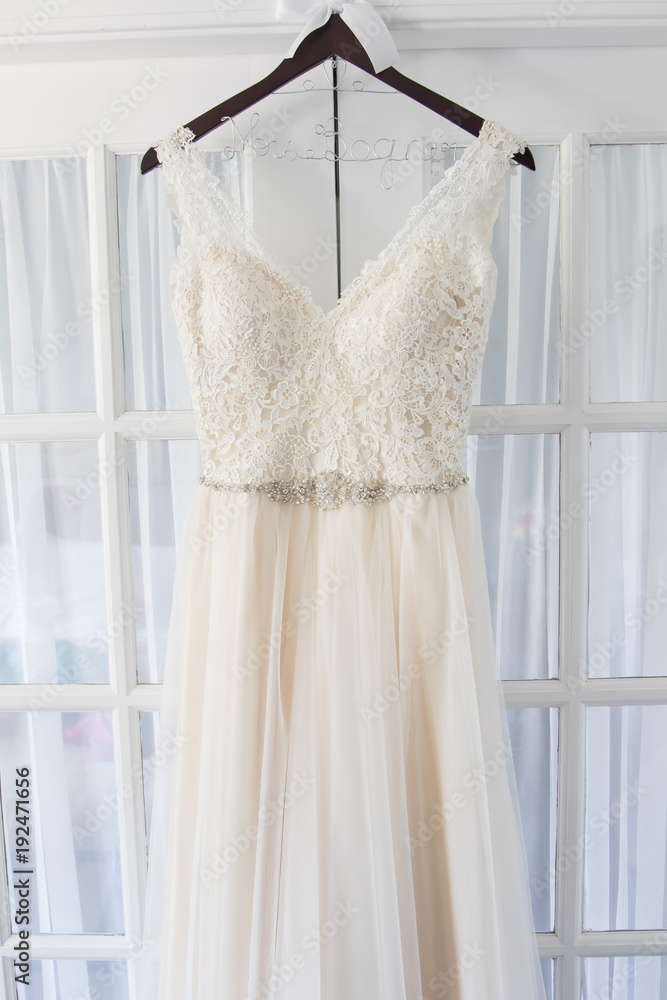Wedding dress hanging on door Wedding dress hanging on door